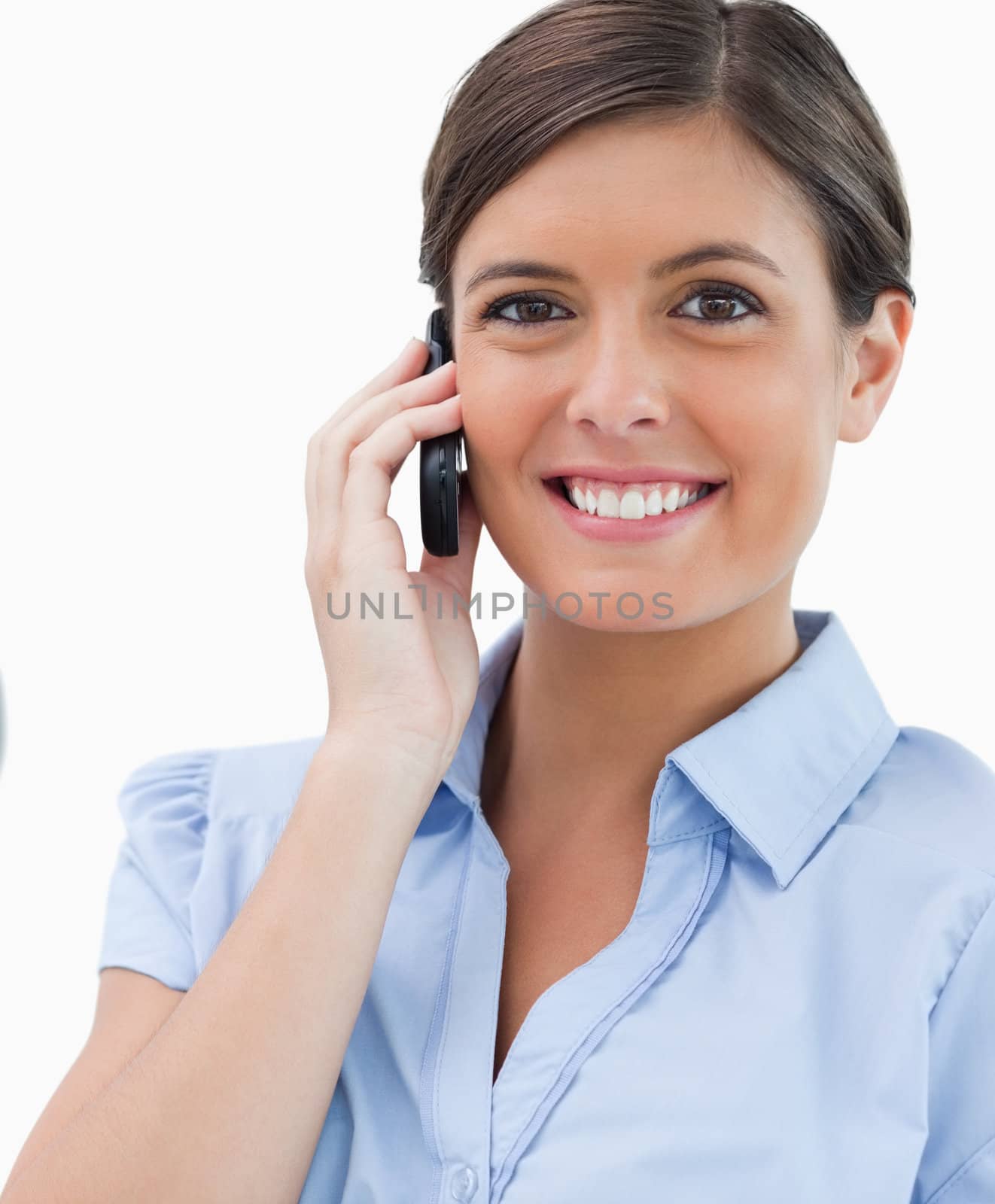 Smiling businesswoman with cellphone against a white background