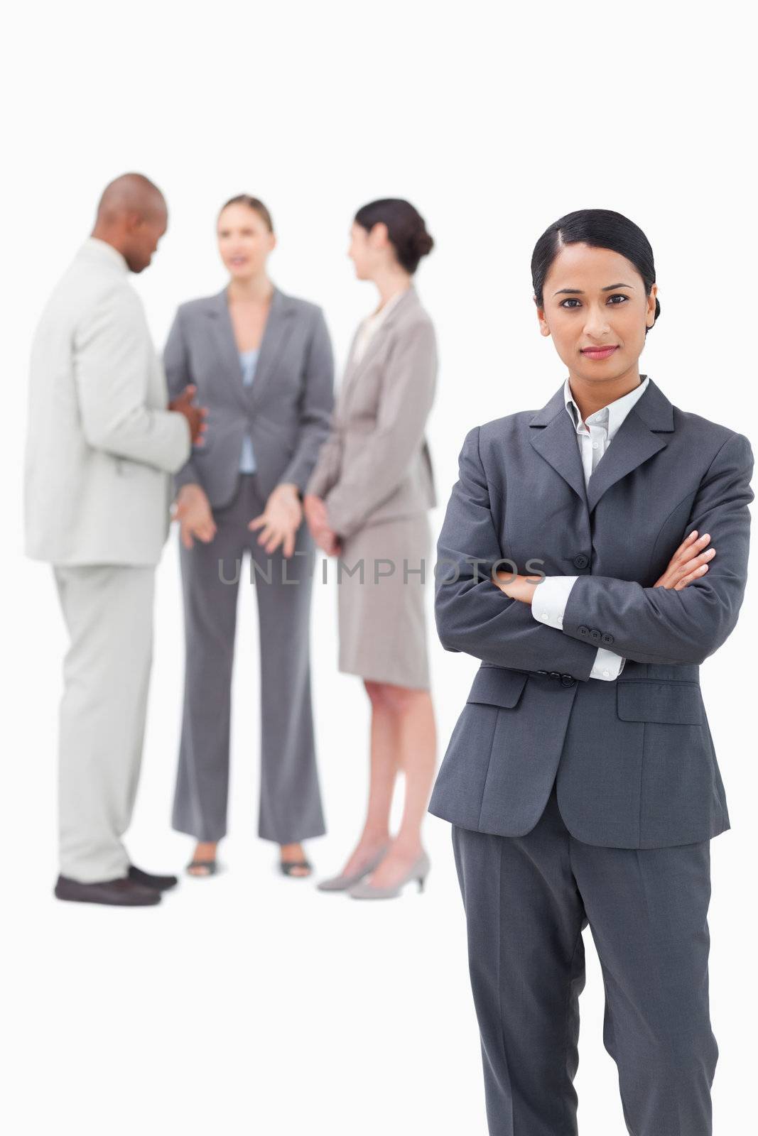 confident saleswoman with negotiating trading partners behind her against a white background