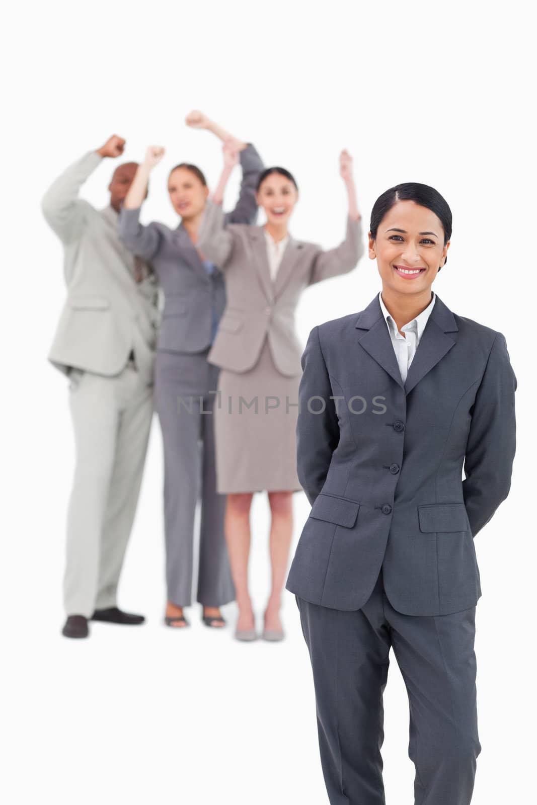 Saleswoman with cheering team behind her against a white background