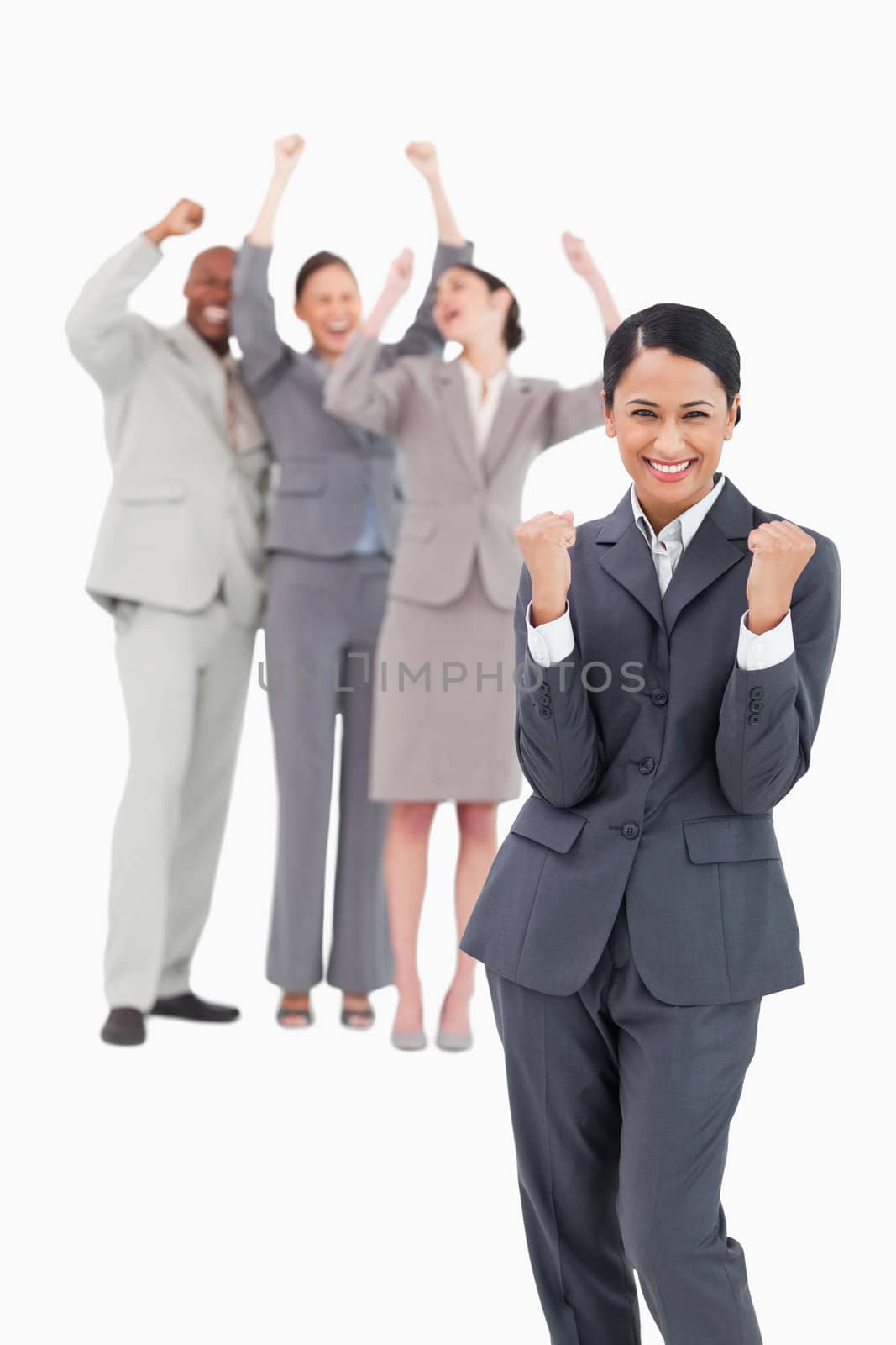 Successful saleswoman with cheerful team behind her against a white background