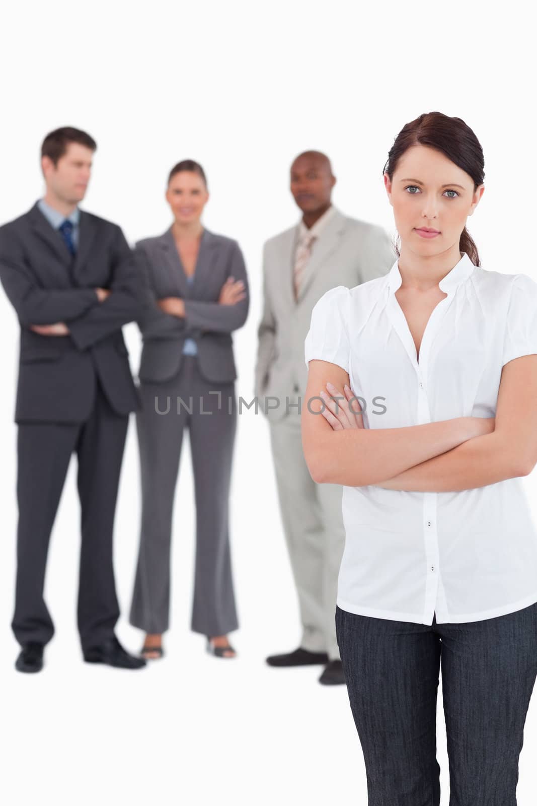 Tradeswoman with arms folded and three colleagues behind her against a white background