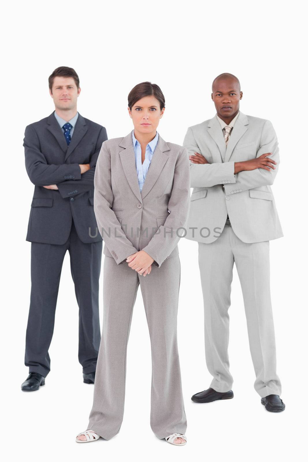 Confident salesteam standing together against a white background