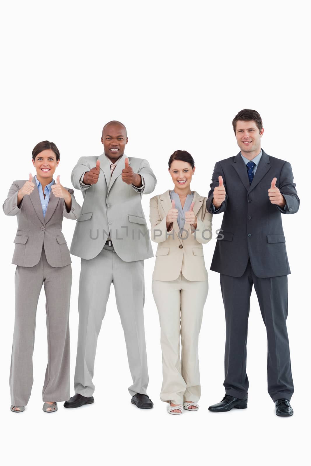 Businessteam giving thumbs up together against a white background