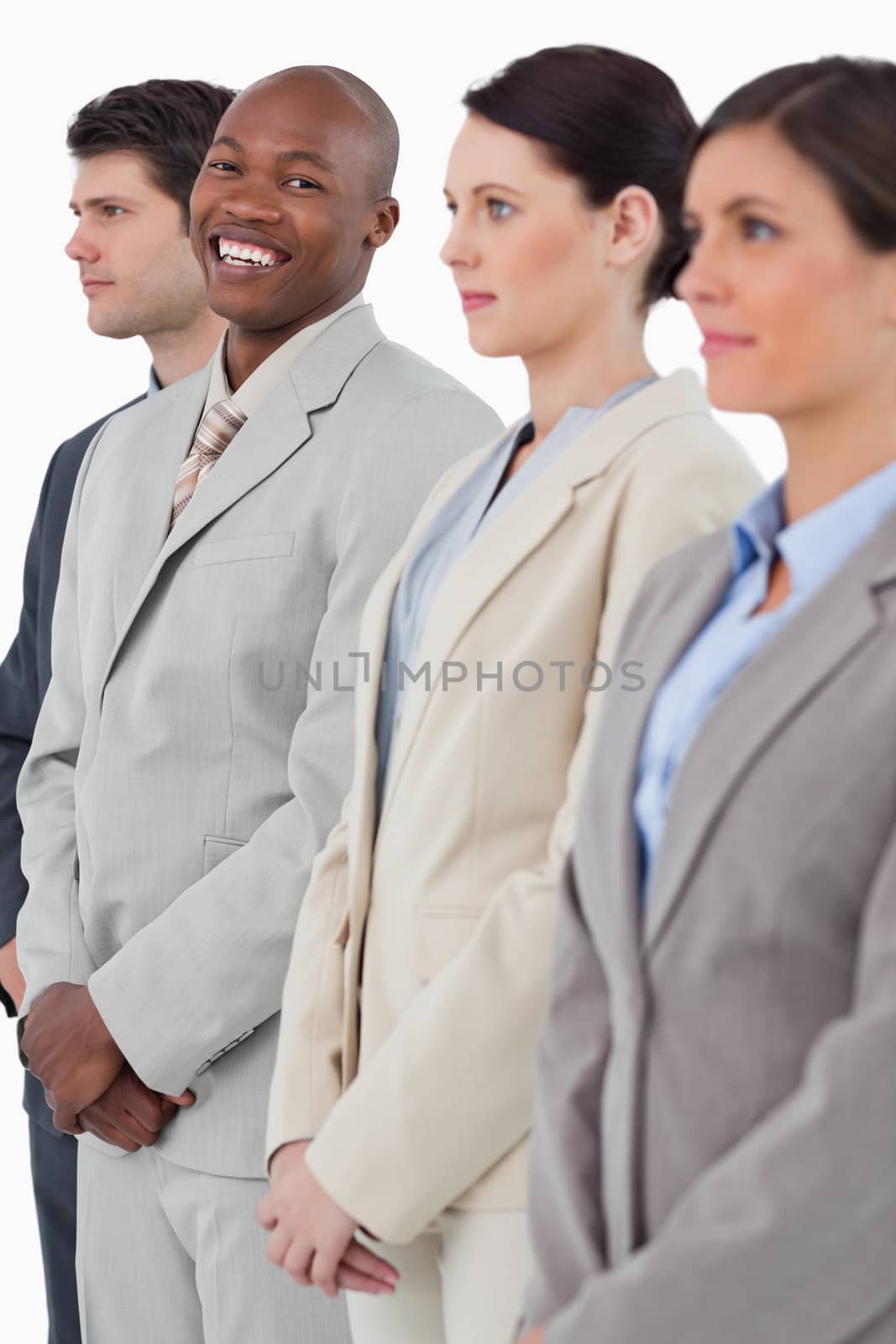 Smiling businessman standing between his associates against a white background