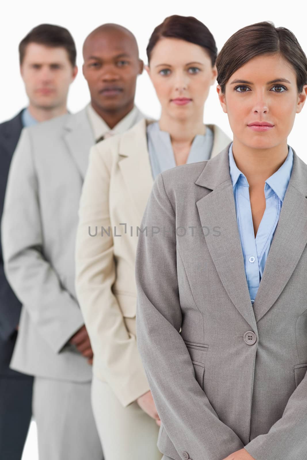 Serious looking businessteam standing together against a white background