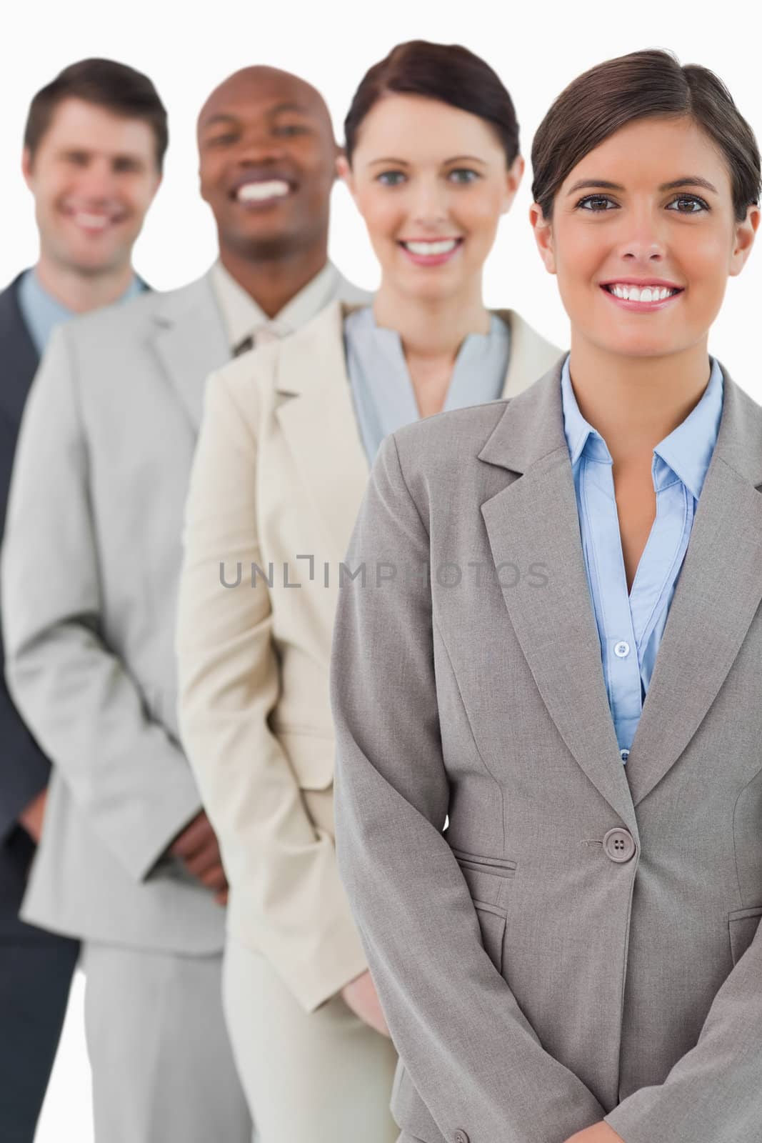 Cheerful smiling businessteam standing together against a white background