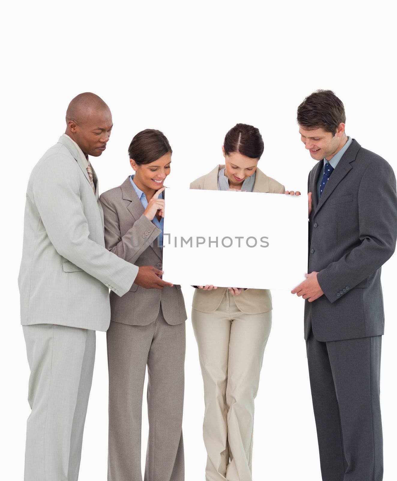 Salesteam holding blank sign together against a white background