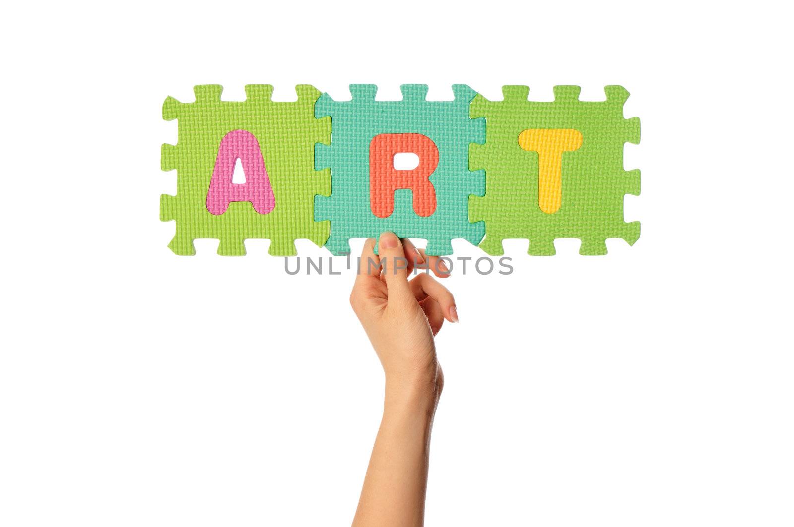 teacher holding in the hand the amusing colored educational puzzles with the word art