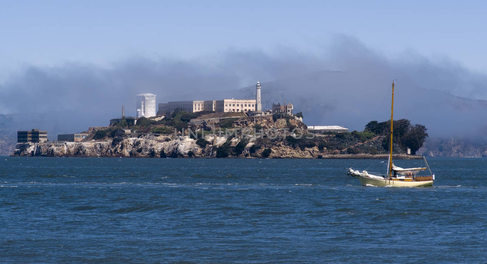 The bay in San Francisco with Alcatraz island and a sailboat passing