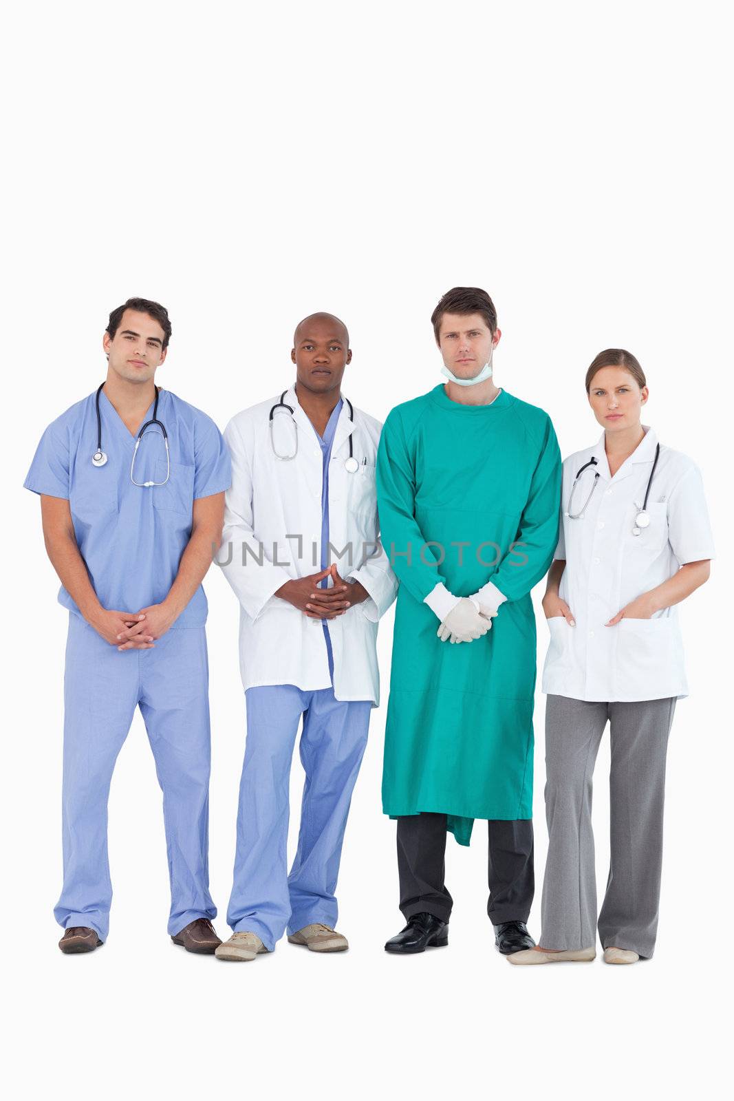 Confident medical team standing together against a white background