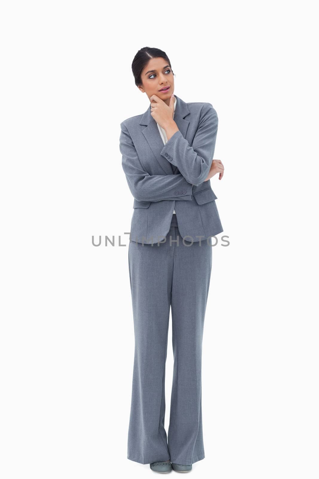 Thoughtful businesswoman looking to the side against a white background