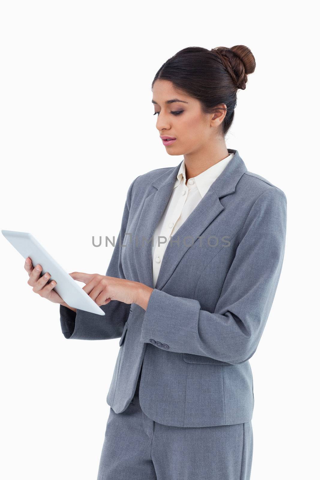 Saleswoman using tablet computer against a white background