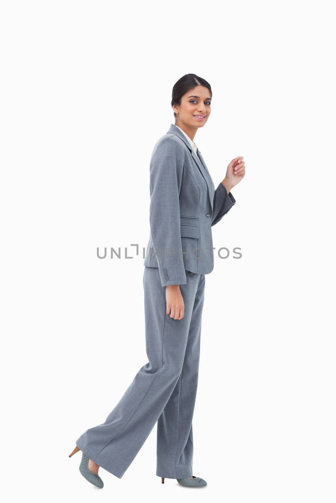 Side view of smiling businesswoman against a white background