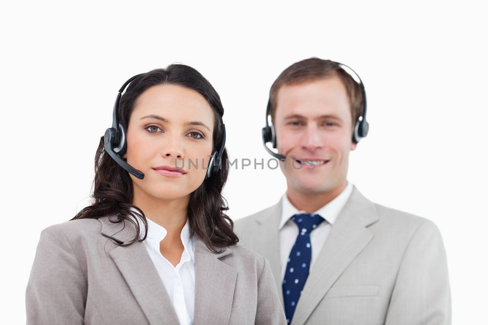 Young call center agents standing together against a white background