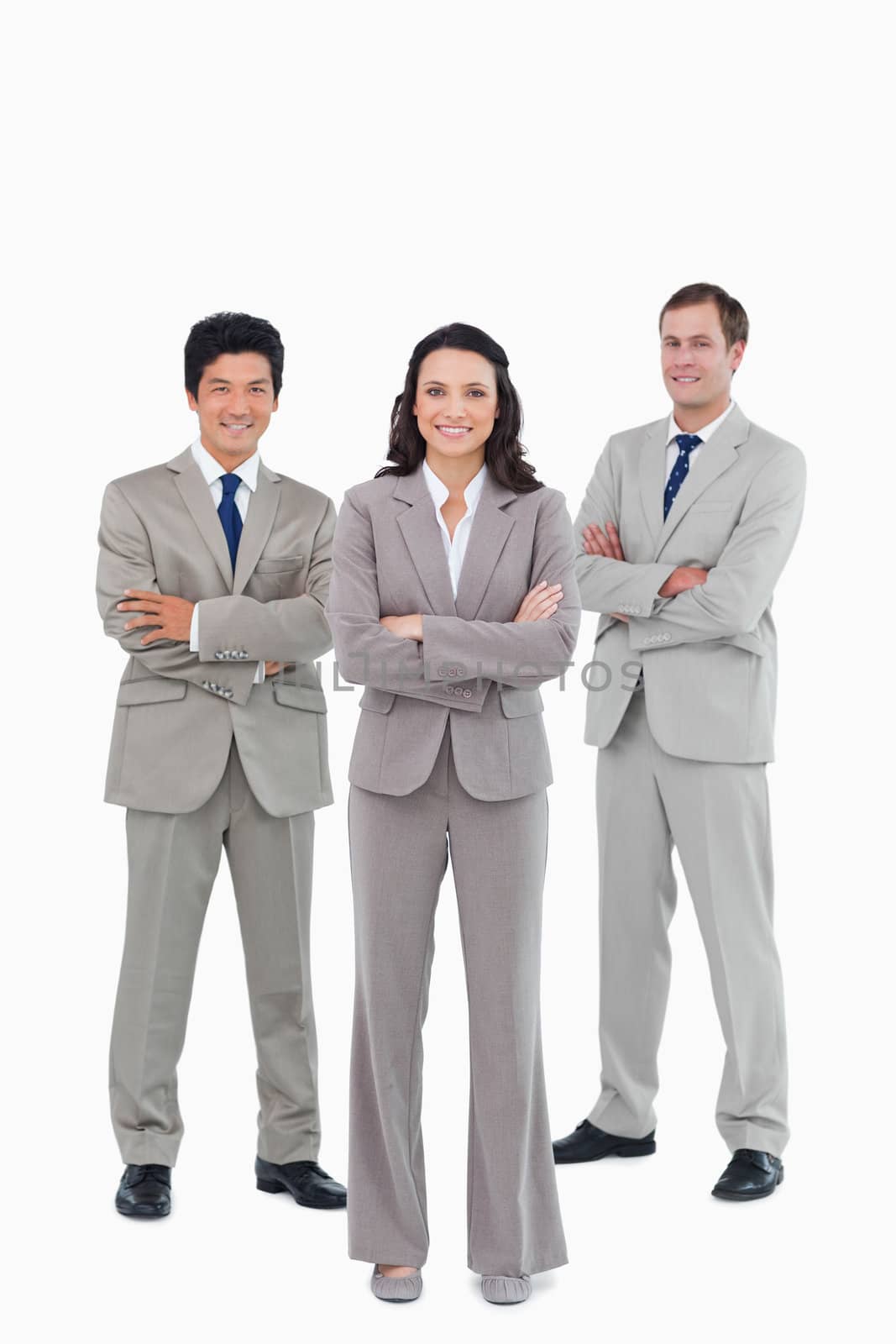 Smiling young tradesteam with arms folded against a white background