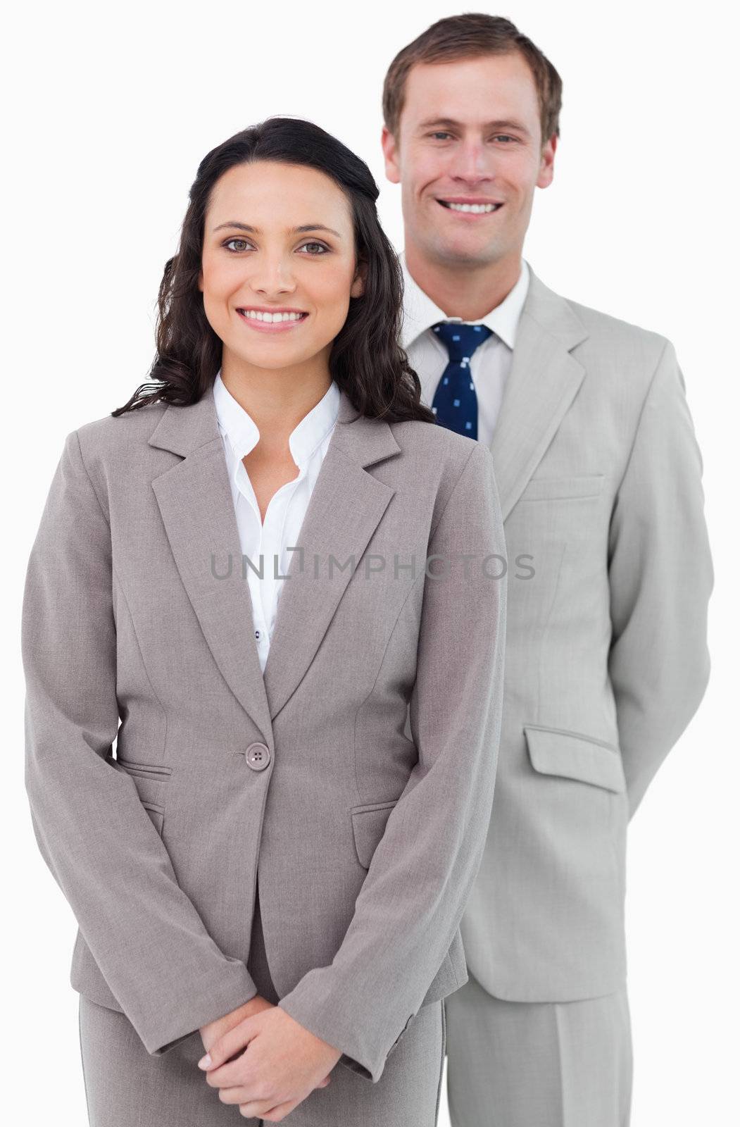 Smiling office staff standing together against a white background