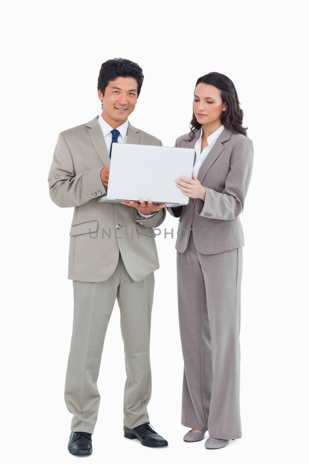 Young salesteam together with laptop against a white background