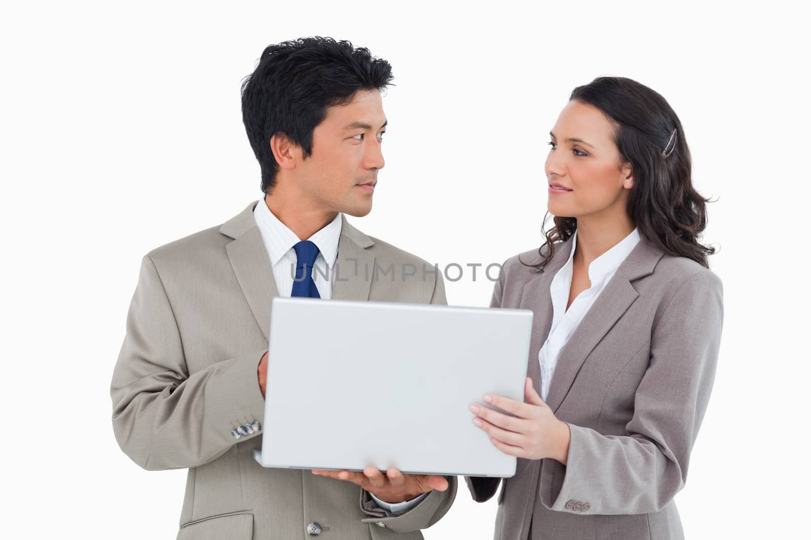 Salesteam working on laptop together against a white background