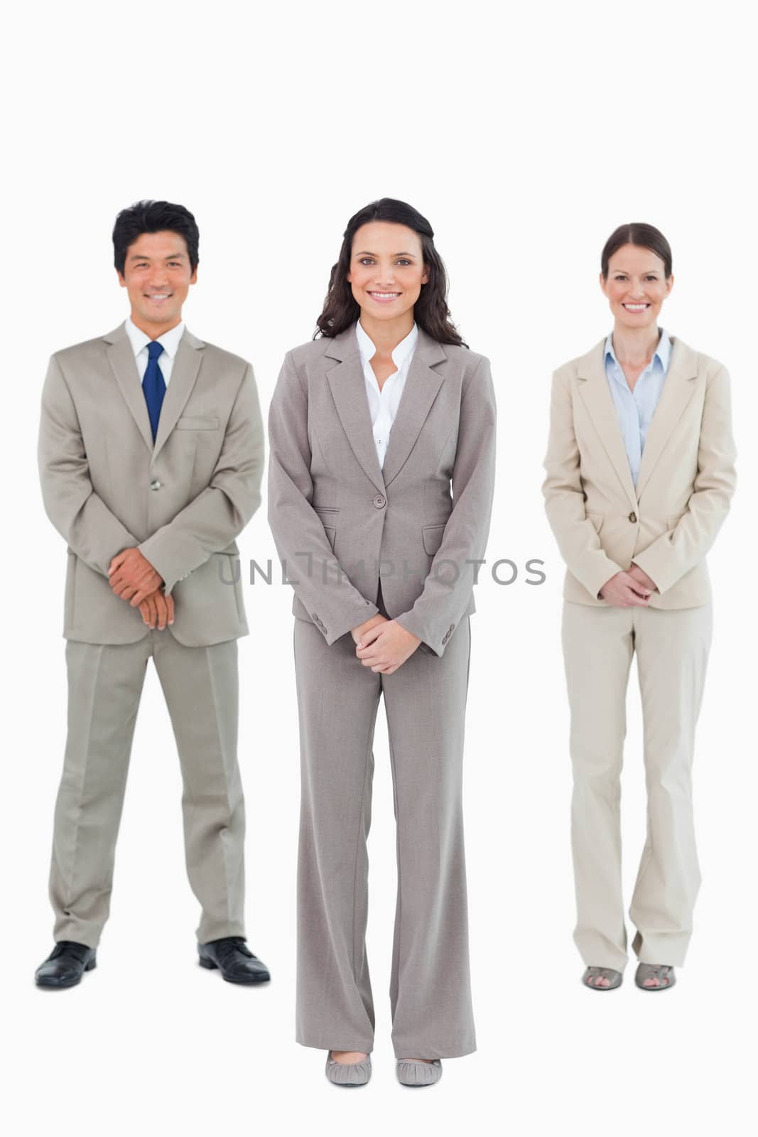 Smiling businesswoman with her team behind her by Wavebreakmedia