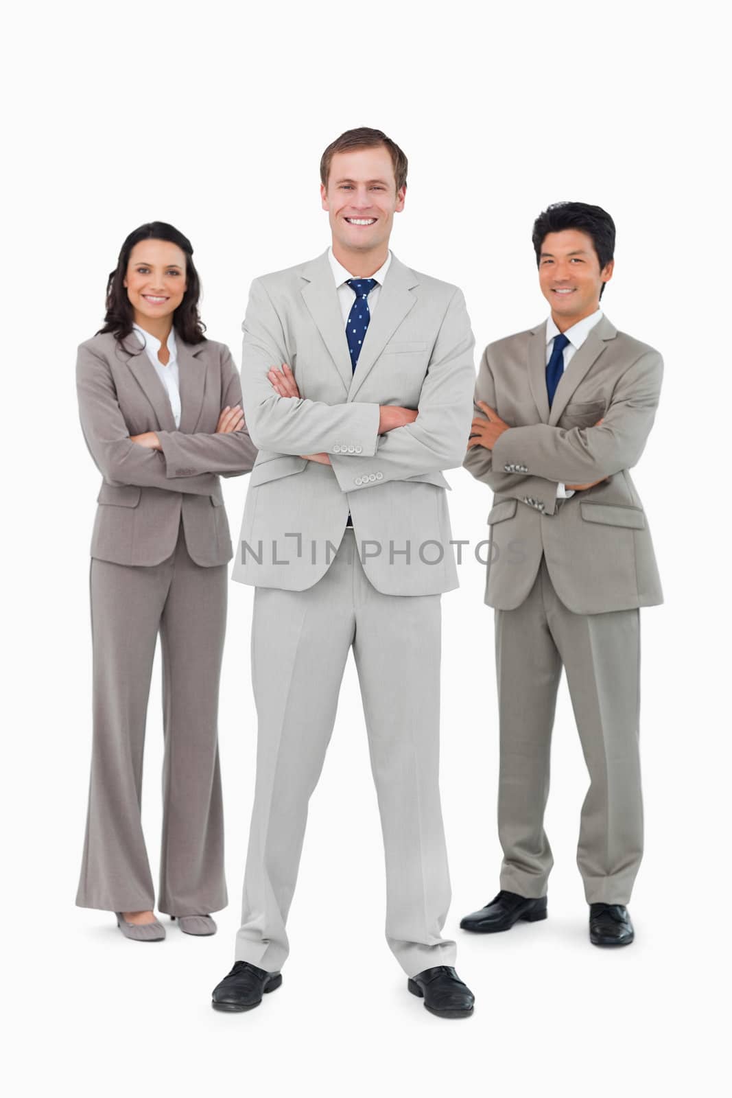 Smiling businessteam with folded arms against a white background