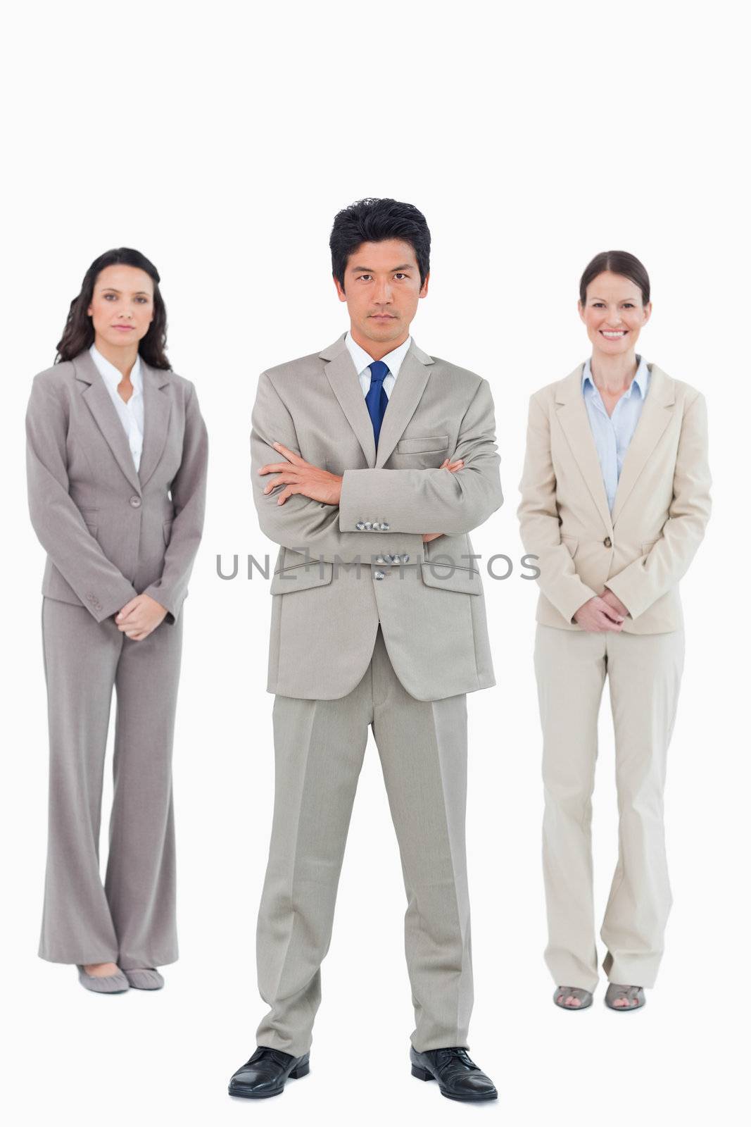 Confident businessman with his team behind him against a white background