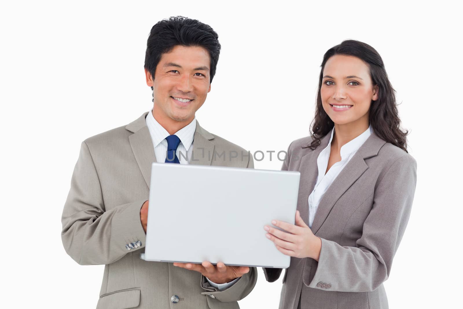 Smiling salesteam with laptop against a white background