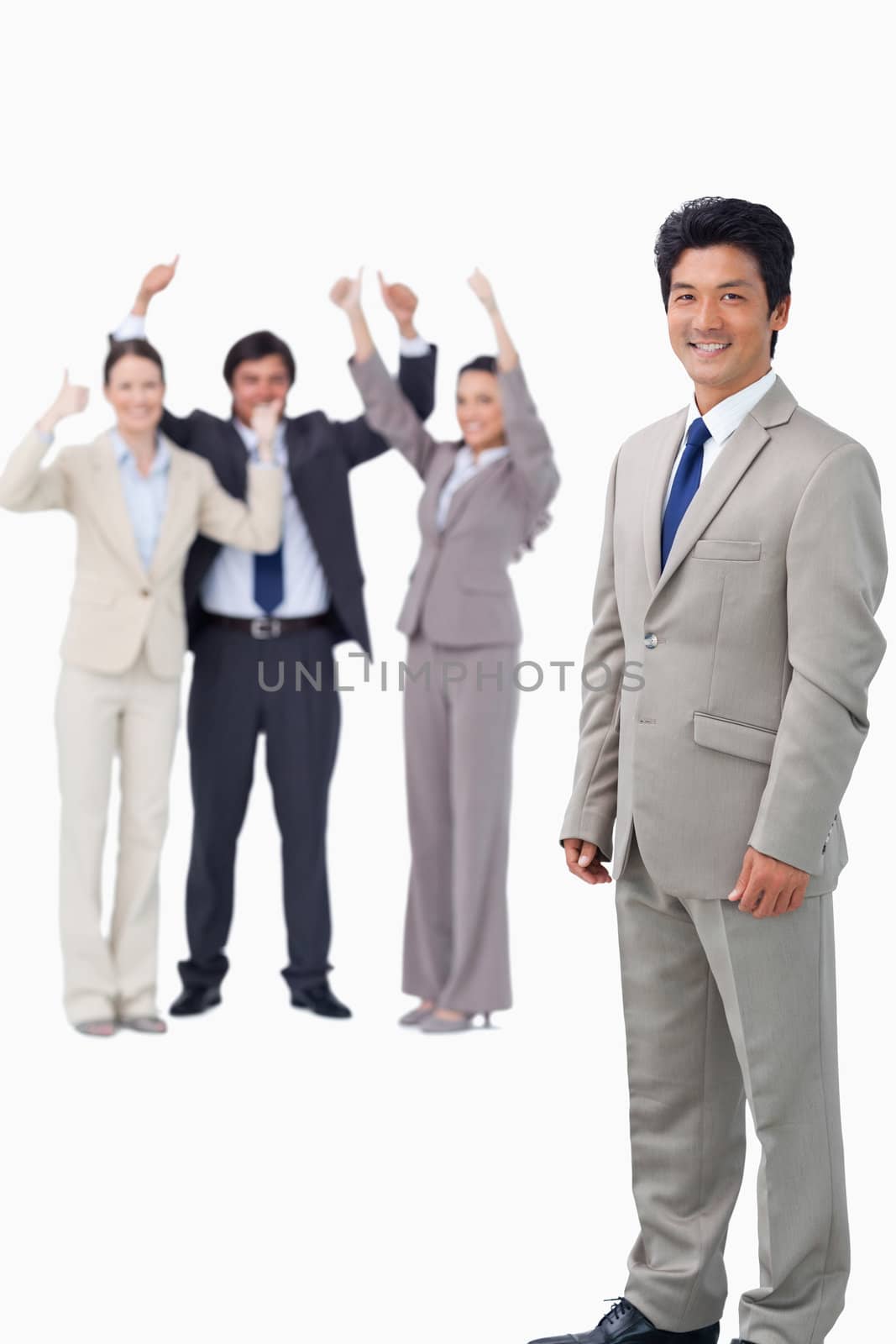 Salesman getting celebrated by his team against a white background