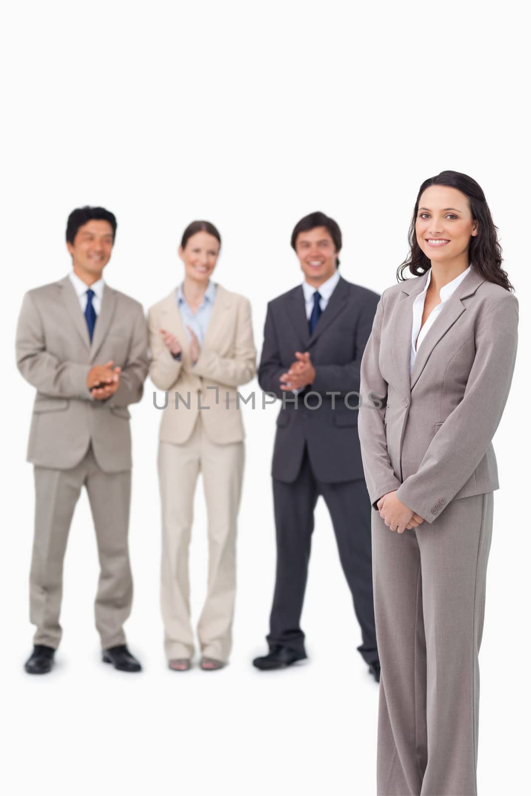 Businesswoman getting applause by her colleagues against a white background