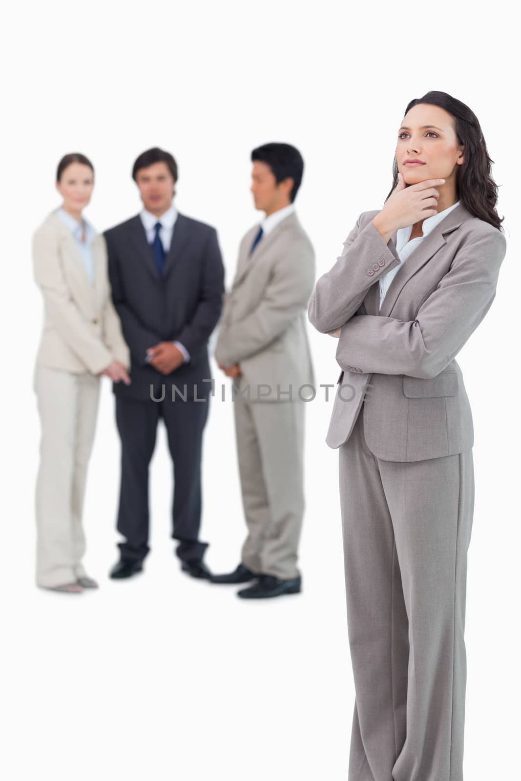 Thoughtful saleswoman with team behind her against a white background