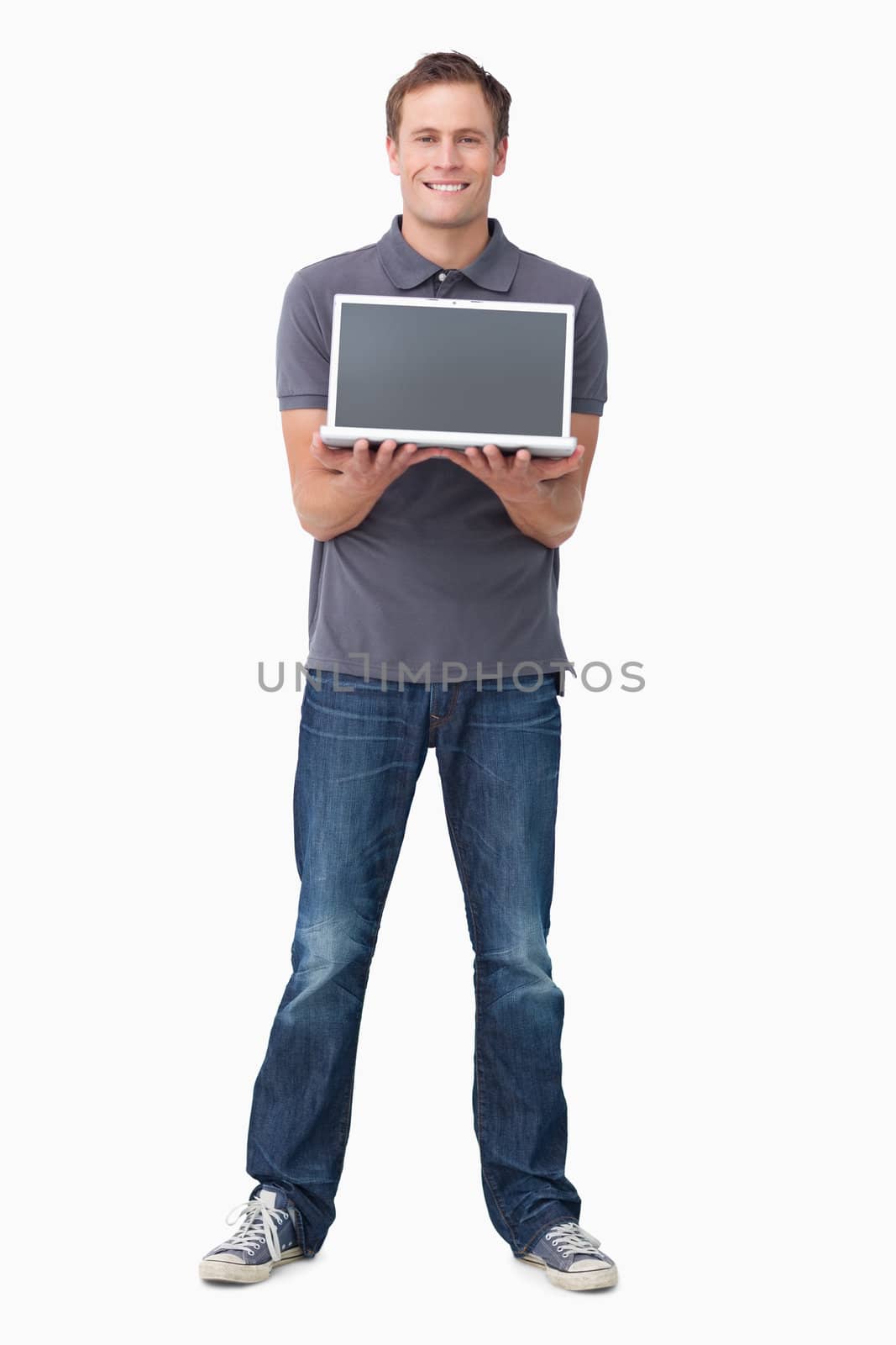 Smiling young man showing his laptop screen against a white background
