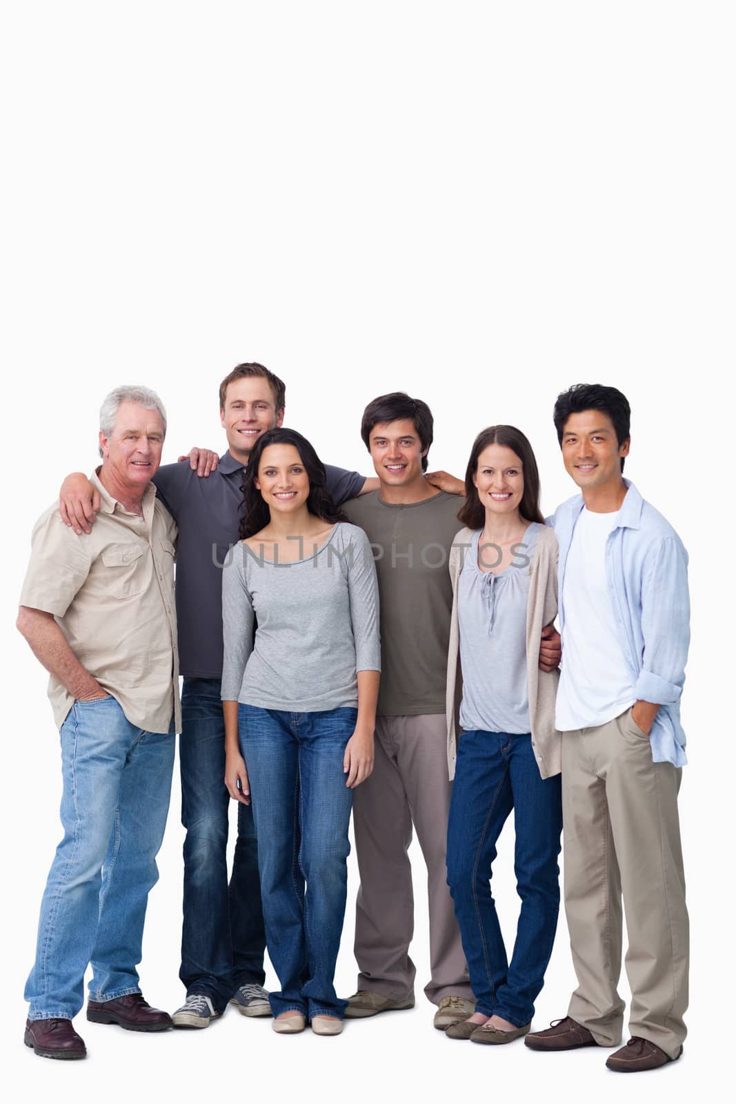 Smiling group of friends standing together against a white background