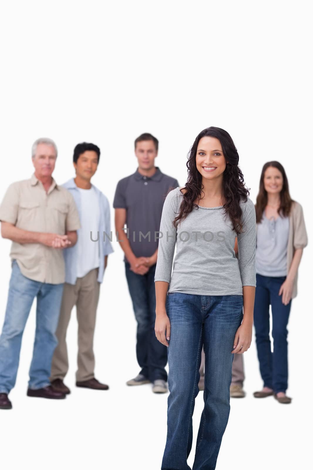 Smiling woman standing with friends behind her against a white background