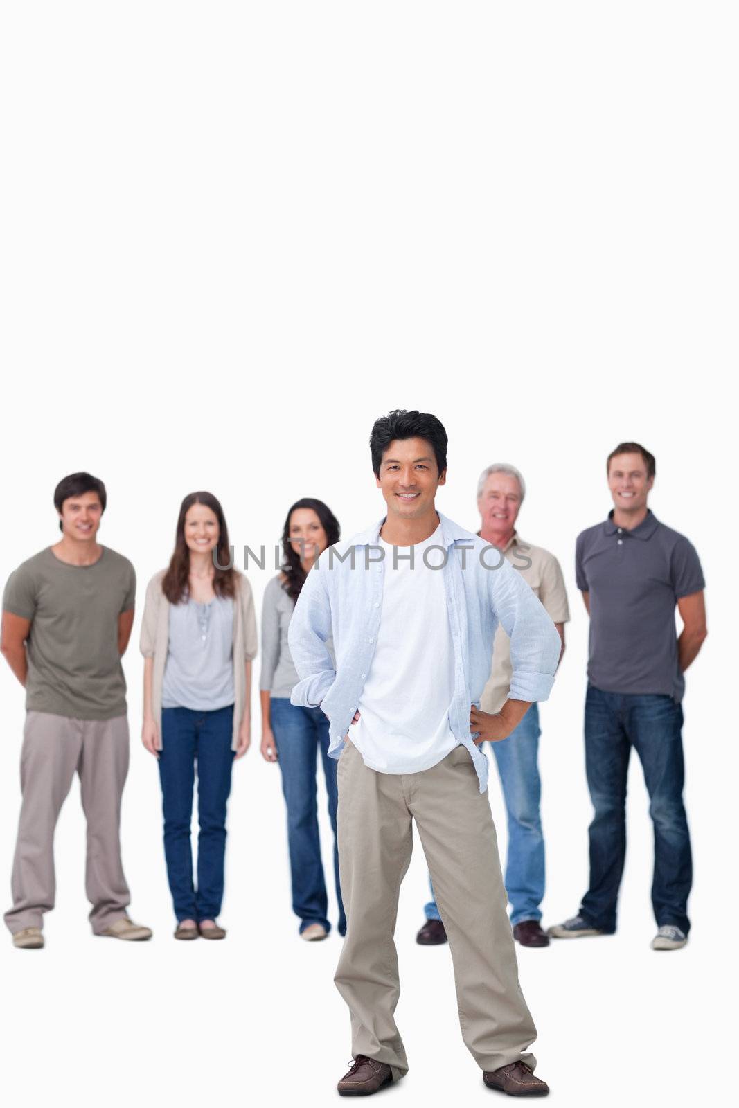 Man with hands on his hip and friends behind him against a white background