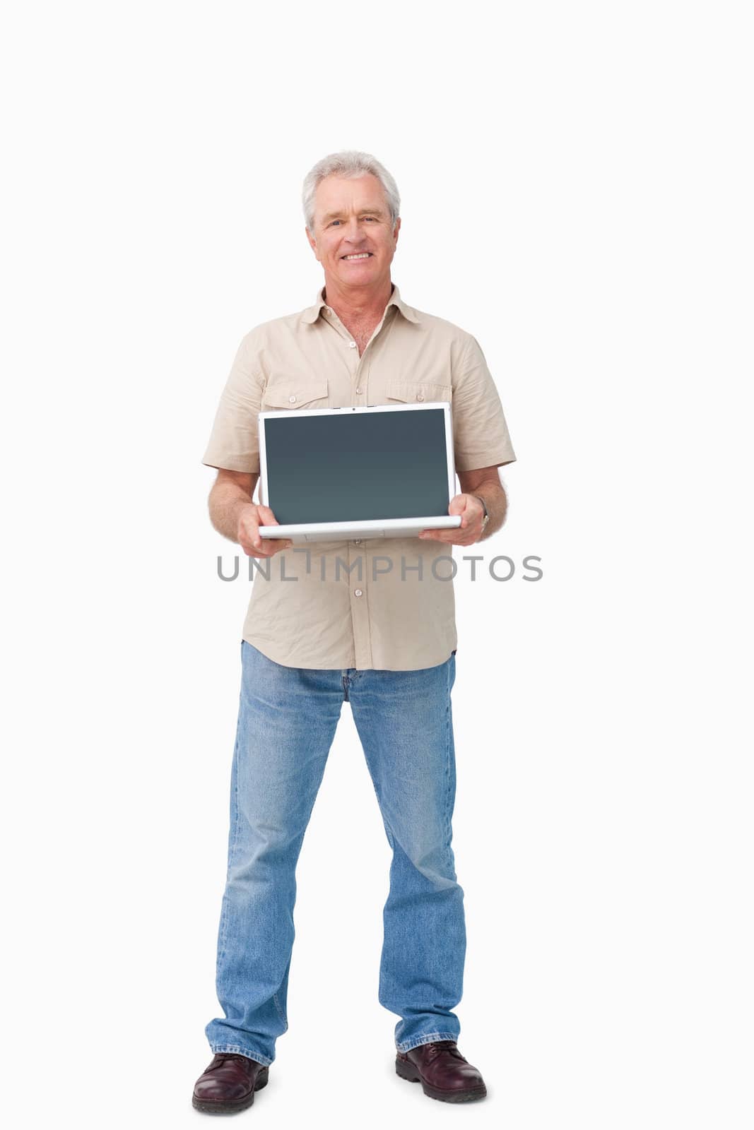 Smiling mature male presenting his laptop screen against a white background