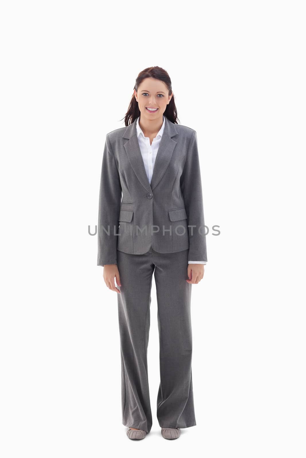 Smiling businesswoman standing against a white background