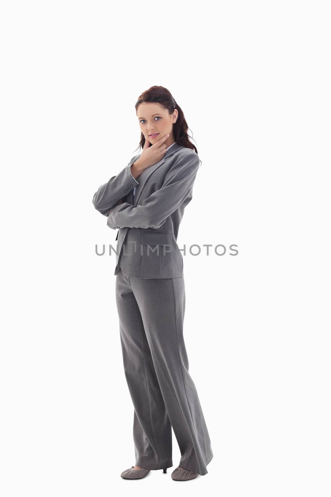 Profile of businesswoman with the hand on her chin against white background