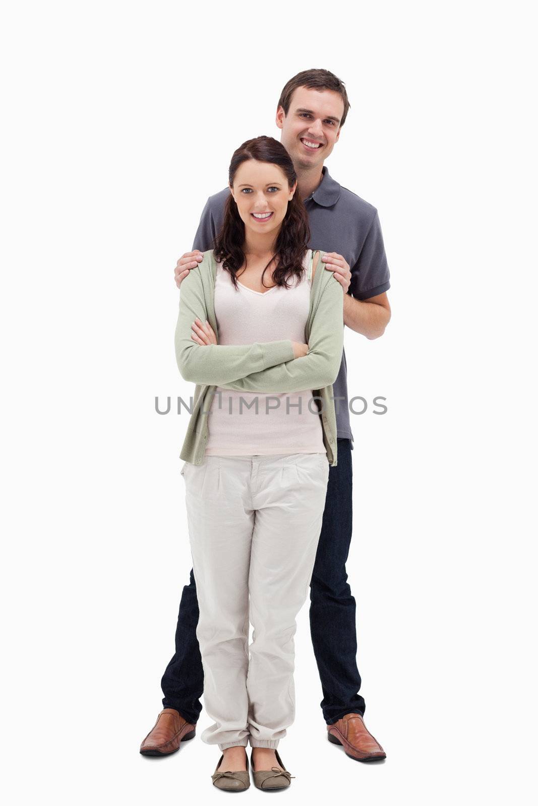 Man holding woman by the shoulders against white background