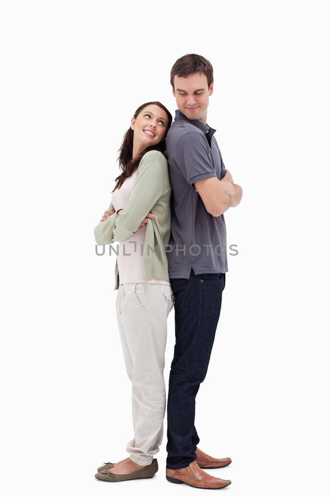 Couple back to back looking each other against white background
