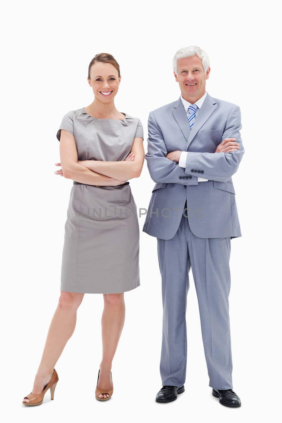 White hair man with woman crossing their arms and smiling against white background