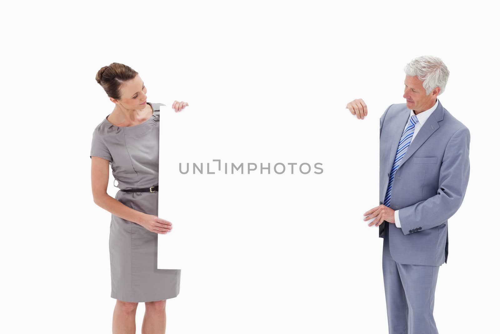 White hair businessman looking and holding a big white sign with a woman against white background