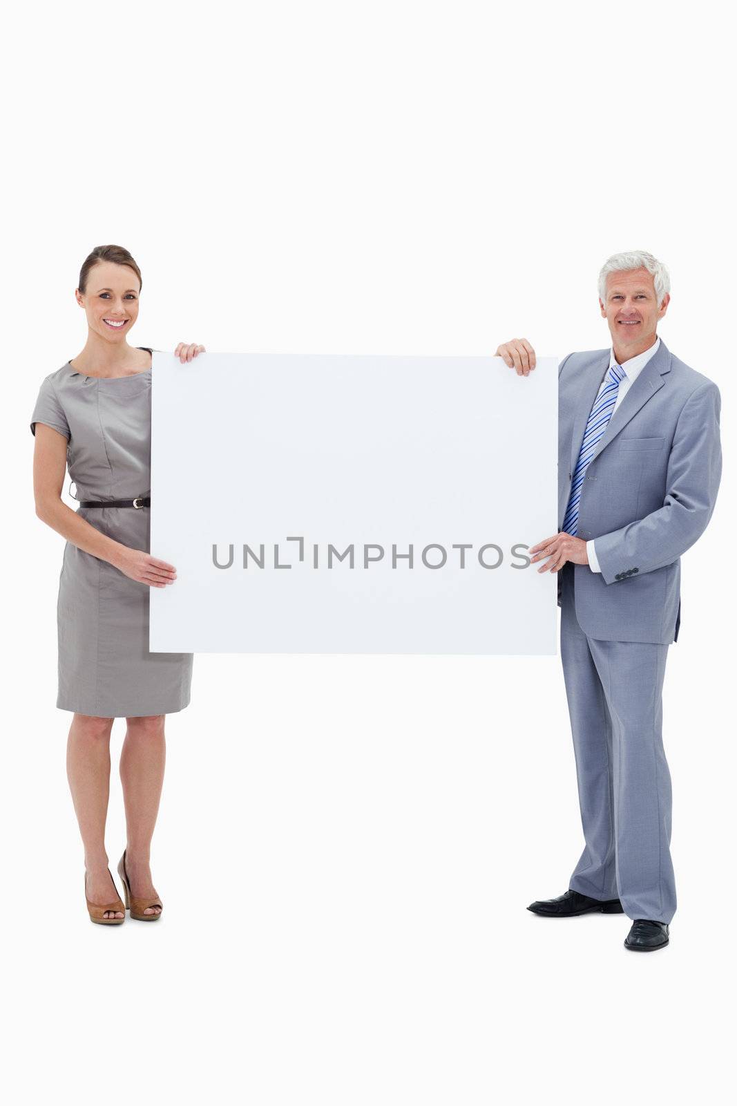 White hair businessman smiling and holding a big white sign with a woman against white background