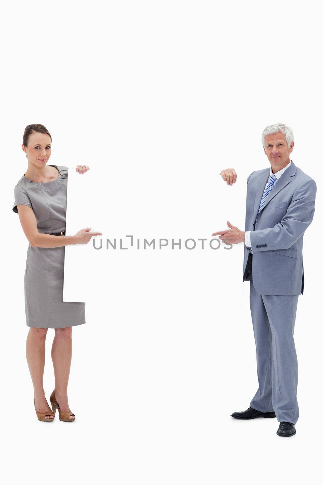 White hair businessman holding and pointing to a big white sign with a woman against white background