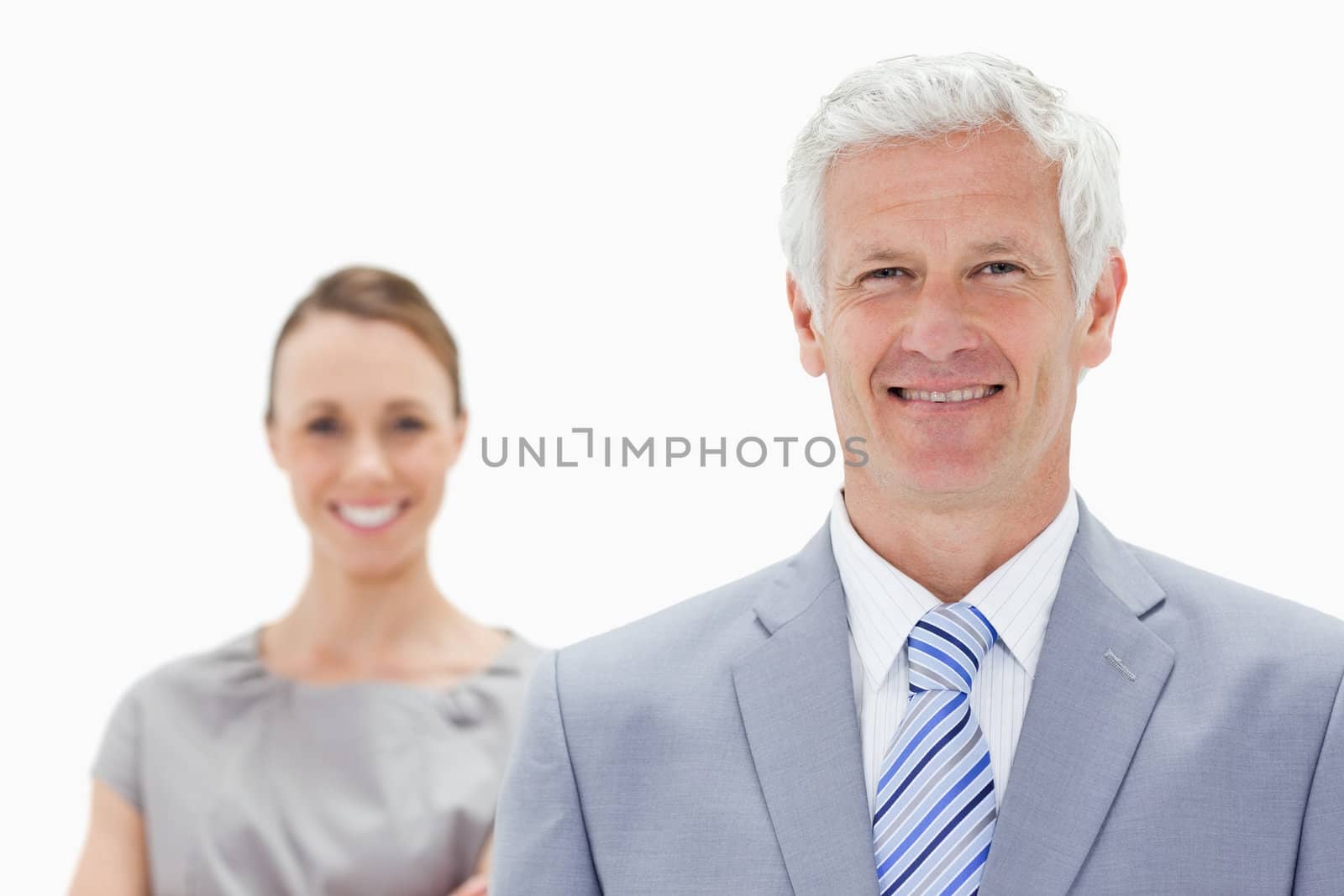Close-up of a happy white hair businessman with a woman smiling behind him against white background