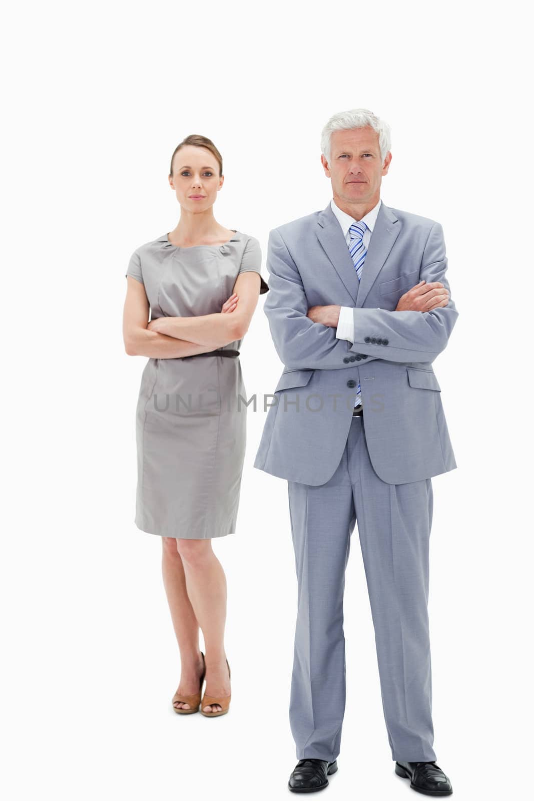 White hair businessman with a woman behind him crossing their arms against white background