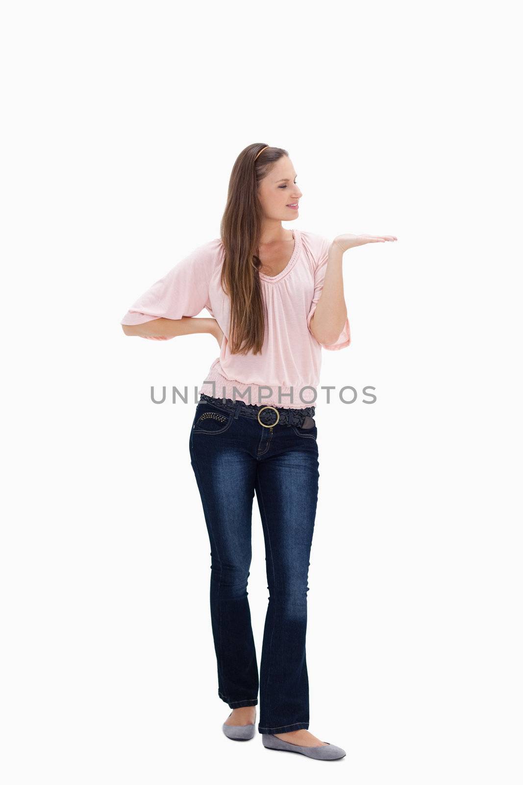 Young woman presenting against white background