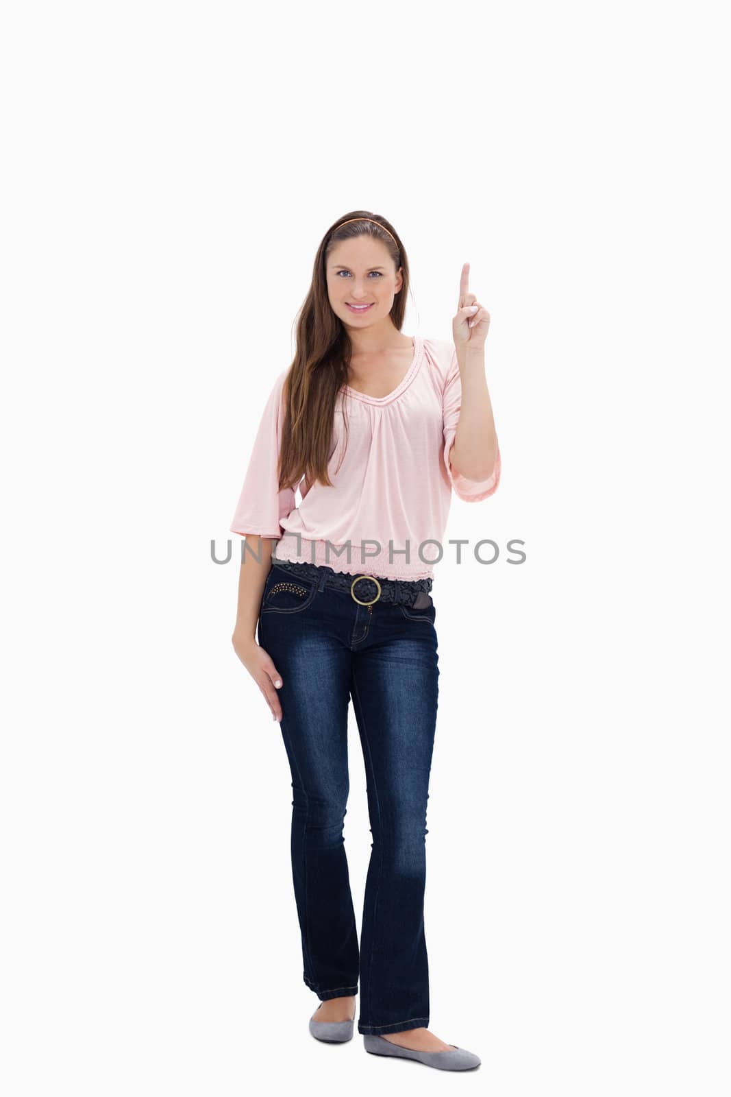 Young woman showing something above with her hand against white background