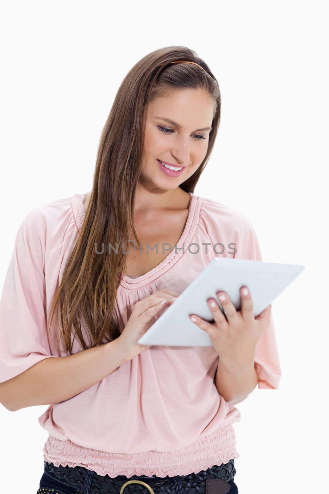 Close-up of a girl using a touchpad against white background