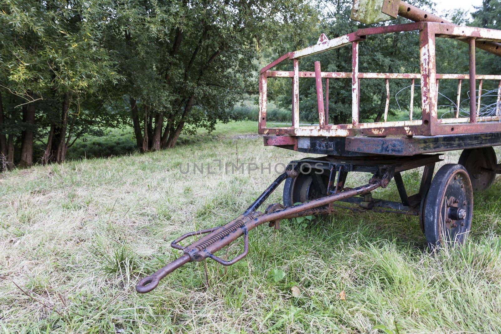 old rusty trailer on meadow. unused for a long time