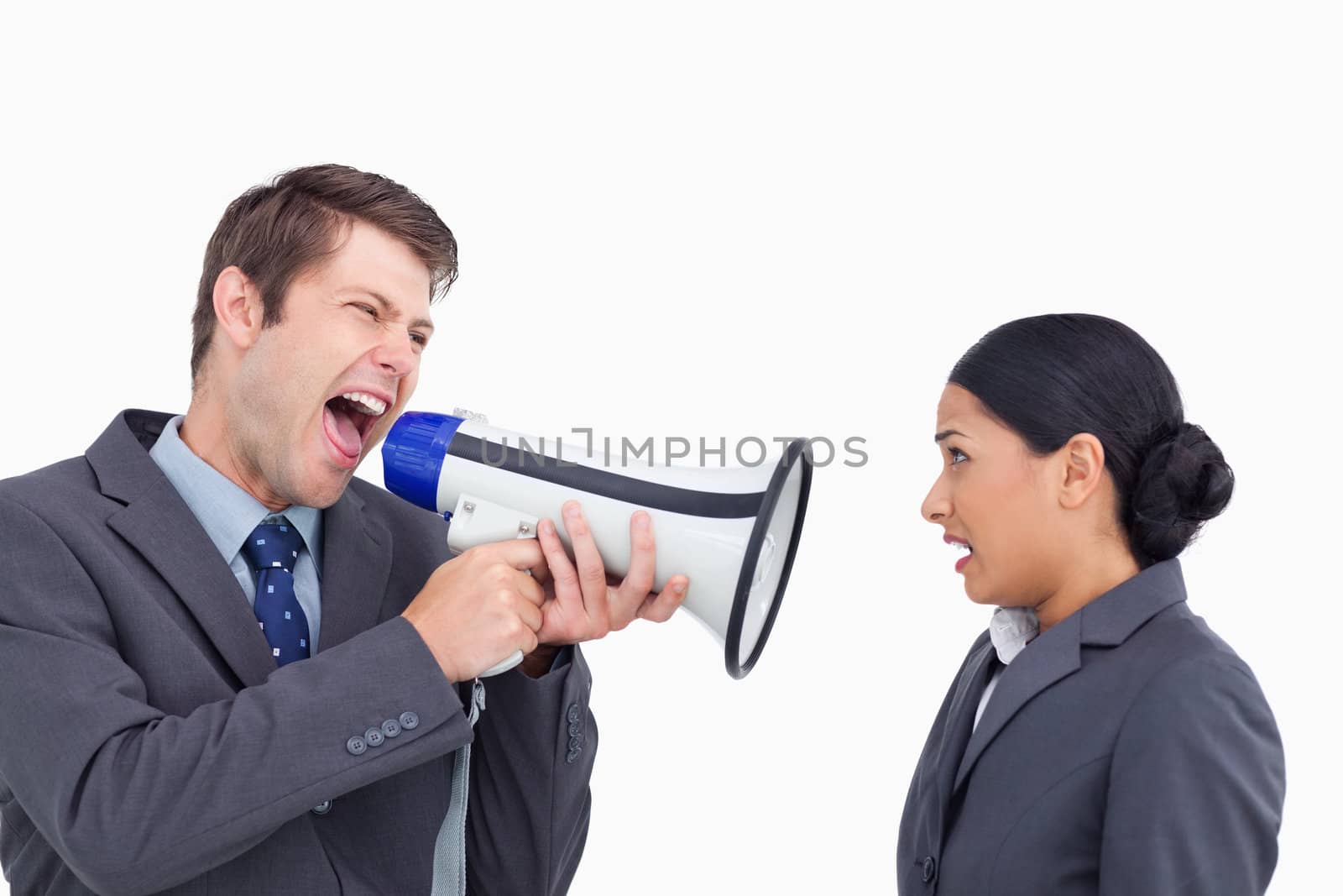 Close up of salesman with megaphone yelling at colleague against a white background