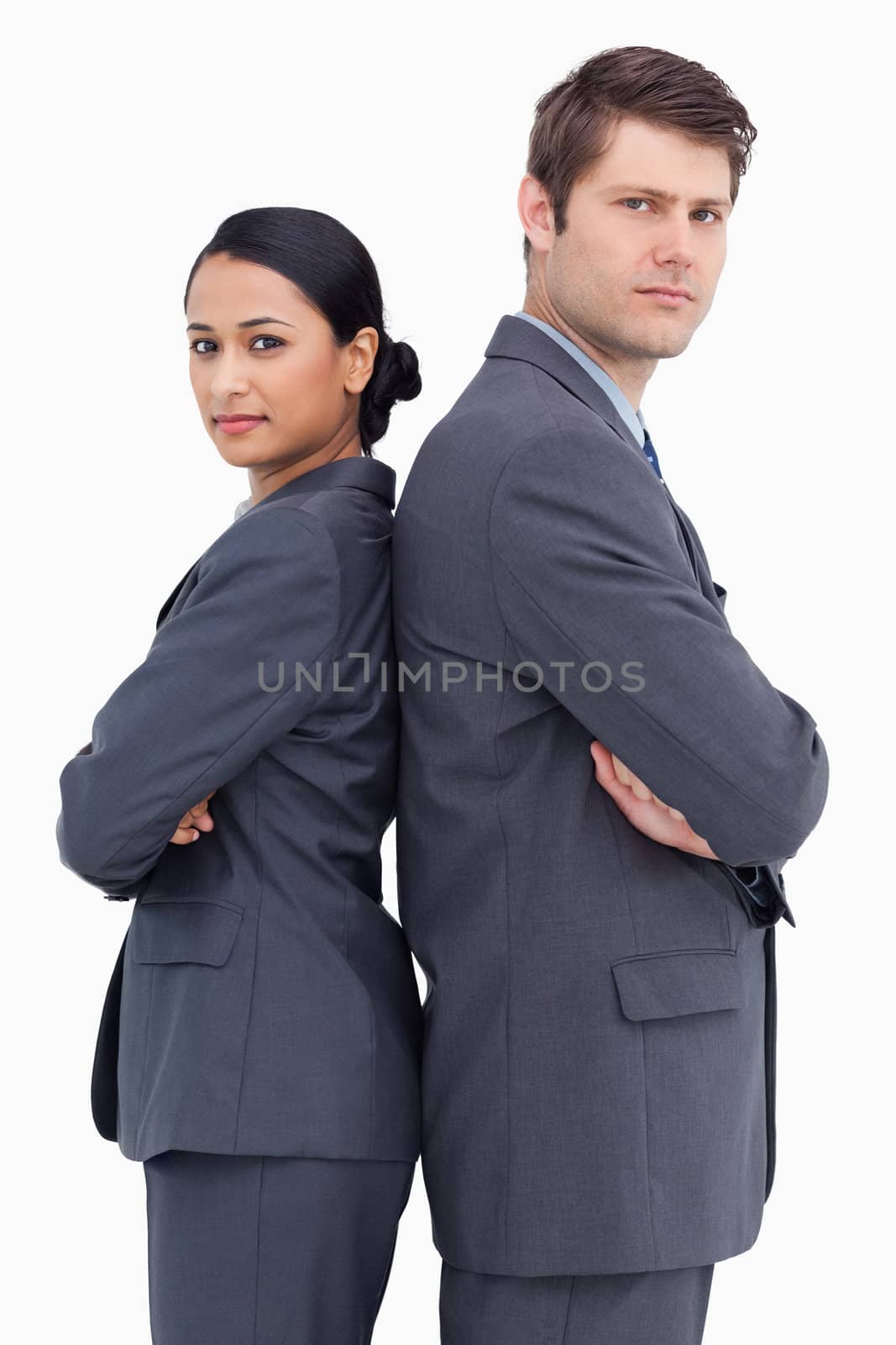 Close up of confident salesteam standing back to back against a white background